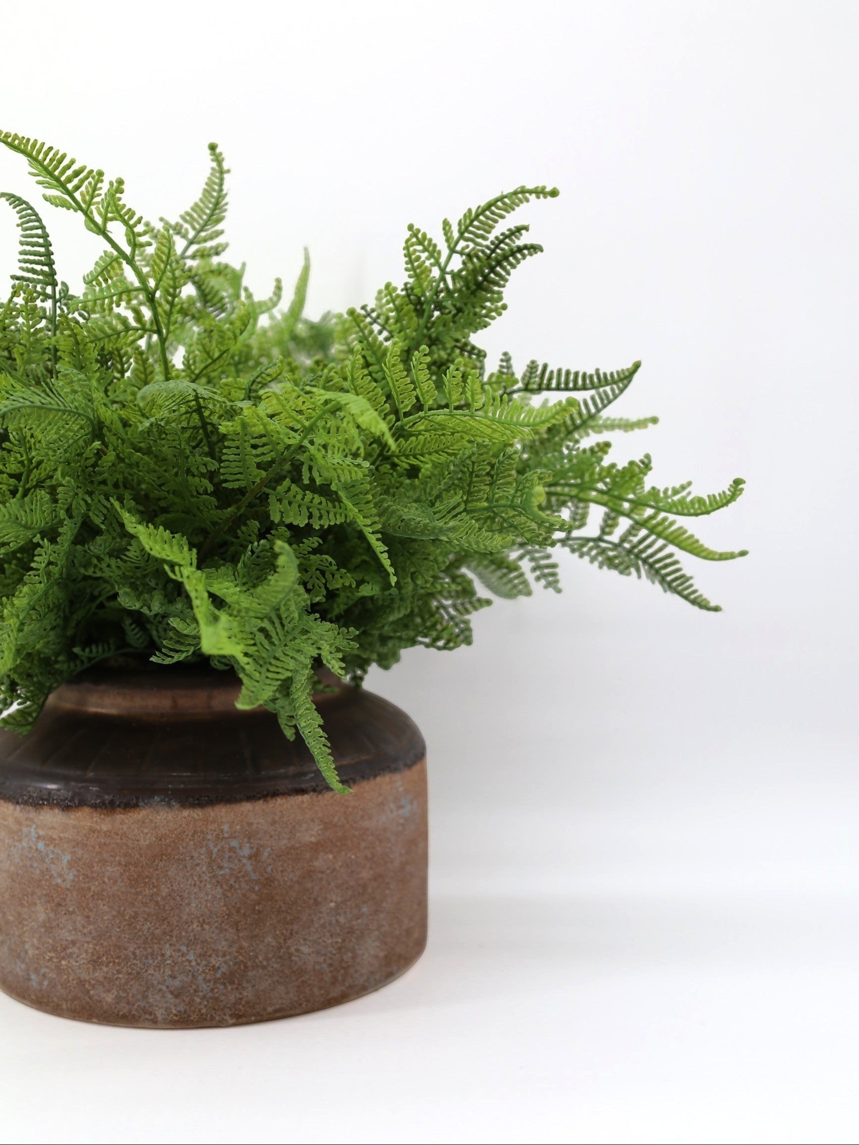 Sixty3 Styled artificial fern plant in a rustic brown and terracotta ceramic pot with detailed green fronds.