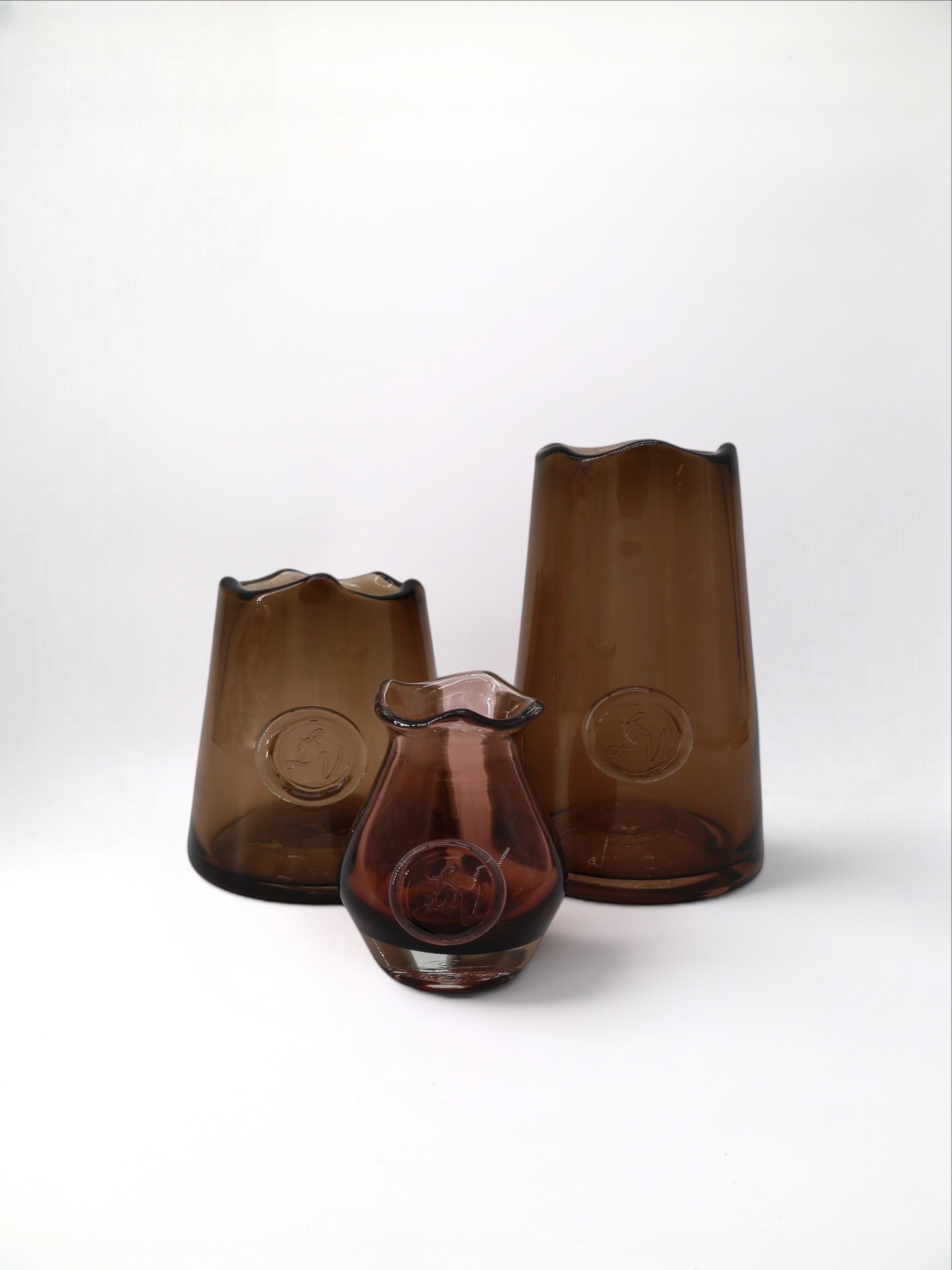 Sixty3 Styled Baby Mia Vase in tea-coloured handblown glass with a unique wavy rim and embossed seal.
