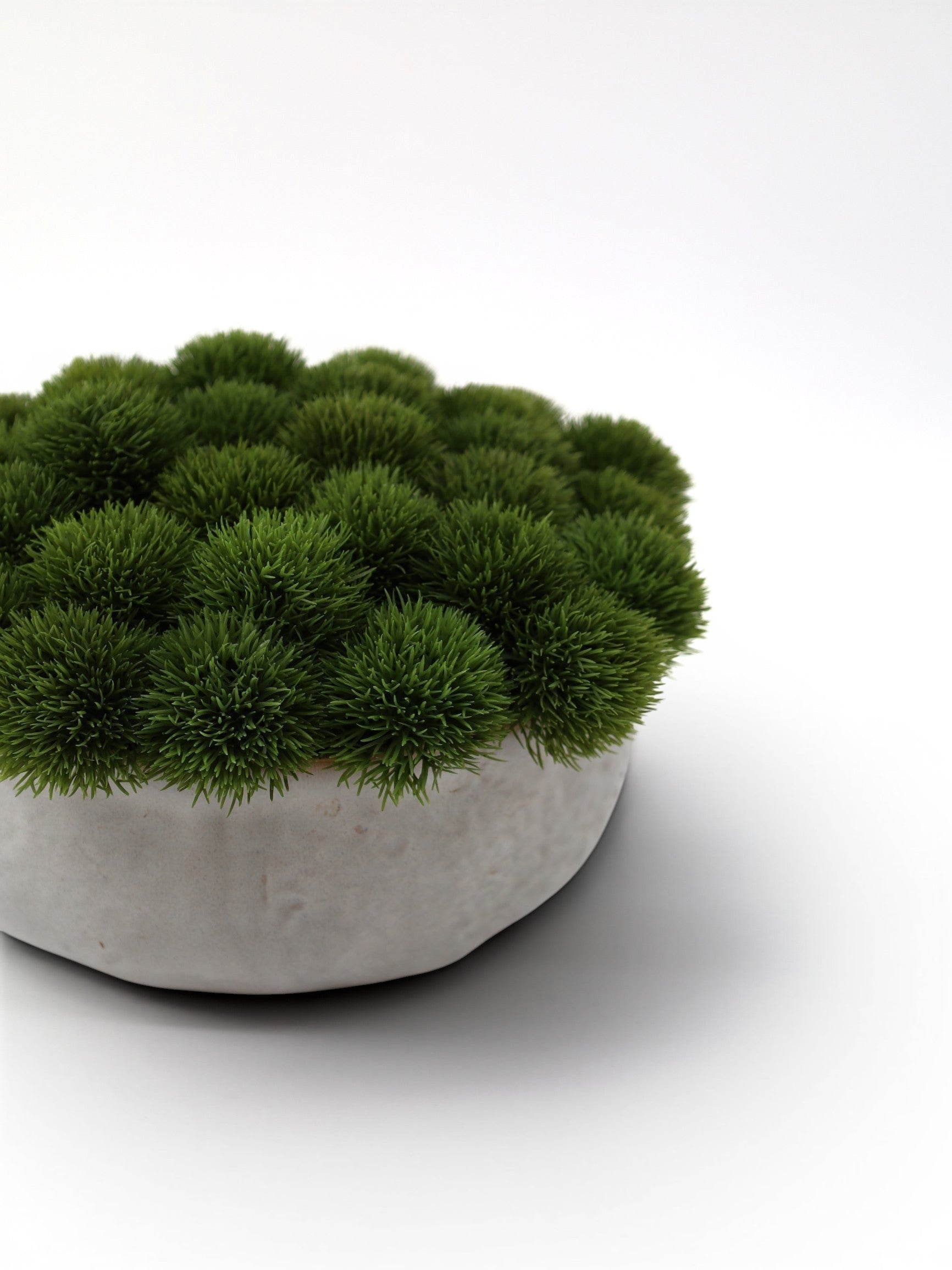 Sixty3 Styled green moss arrangement in a textured concrete-style bowl. Realistic faux moss balls create a dense, vibrant display.